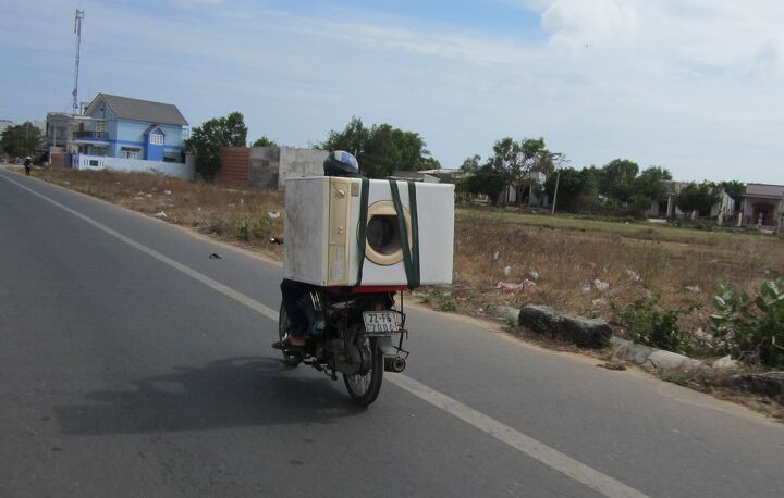 motorcycling in vietnam, Just a lady carrying a washing machine on her bike no big deal Welcome to Vietnam