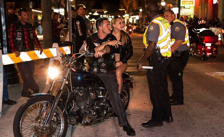 2014 daytona bike week mid week update, Despite the ticket book in his hand everyone used their party manners as the police officer asked the couple to pull a little further off the street