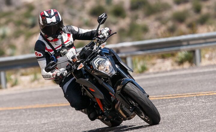 2014 super naked street brawl video, Unlike the flowing corners on a track tight canyon roads reveal the SDR s gangly nature Transitioning from one side to the other the tall and long wheelbase KTM travels more distance and feels physically largest