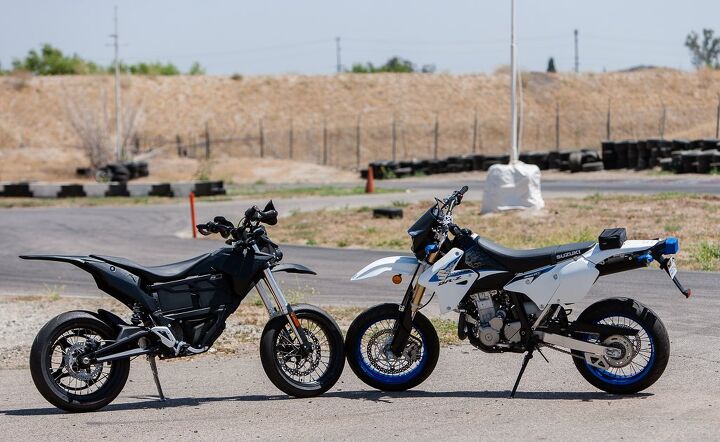 electric vs gas supermoto shootout, The Suzuki DR Z400SM is an out of the box supermoto while the Zero FX began life as a dual purpose bike with 21 inch front and 18 inch rear wheels and a miniscule front brake Both come outfitted with all the requisite streetable legalities