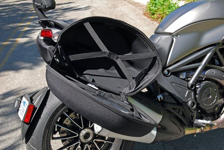2013 2014 ducati diavel strada review, Ducati says there s 41 liters of storage in each semi hardshell saddlebag While they re fairly roomy and conveniently detachable they lack the security and style of hardshell bags with integrated locks