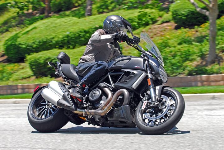 2013 2014 ducati diavel strada review, Despite disproportionately wide rear rubber this so called cruiser will have no trouble showing its LED taillight down a twisty road to anything wearing a wheelbase of more than 62 inches