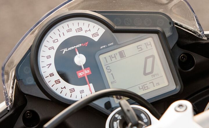 2014 aprilia tuono v4r abs review, The Tuono has the same instrumentation as the RSV4 The analog tach is eminently readable but its square LCD panel displays blocky numbers reminiscent of Atari Also red backlighting at night makes the digits less readable