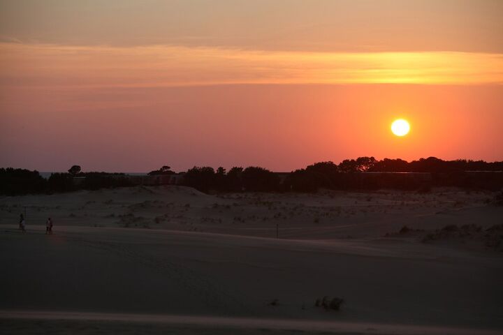 the wings tour 2014 leg two, The sun sets over the sand dunes at Jockey s Ridge State Park The Wright brothers chose North Carolina s Outer Banks as the place for their experiments because the dunes provided a place to launch their gliders and the sand was soft for landings
