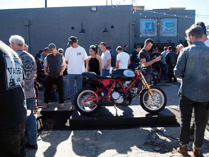 raduno italia dancing with ducs at deus ex machina, Debuted for the party was DEM s new Dreamliner an homage to the Imola racers of the 1970s In this case Woolie s re vamping of a 750 two valve Monster engine fitted into his custom chrome moly frame and fed by a pair of Keihin FCR racing carbs with fully adjustable swingarm