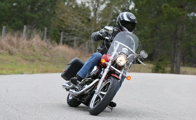 2014 harley davidson superlow 1200t review first ride, The white dots on the right side of the photo are rocks being kicked up by the SuperLow 1200T s dragging peg Not much of a lean angle is it