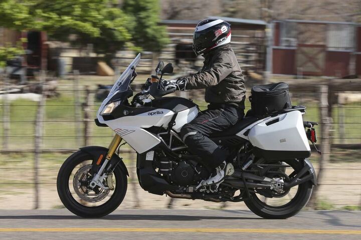 2015 aprilia caponord 1200 abs travel pack review video, Seating position doesn t get much more neutral than this The manual windscreen is a little on the small side but does a commendable job pushing wind over and around the rider