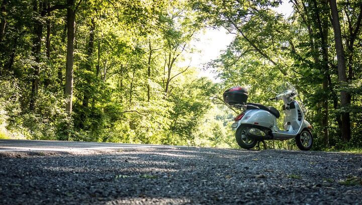 riding and the taste of freedom, Central Pennsylvania has some of the best riding roads in America Here the Vespa pauses during a ride along Spring Creek a favorite with trout fishermen