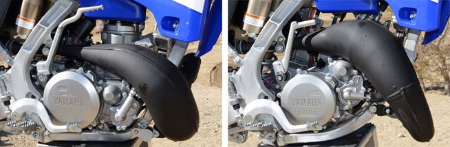 2015 yamaha yz125 yz250 first ride reviews, The YZ250 motor with its low boy pipe is on the left while the YZ125 with its more upward routed pipe is at the right Both machines still rely on good old fashioned carburetors to deliver their premix through reed valves and into their respective combustion chambers A Yamaha Power Valve System alters the exhaust port to broaden the powerband on both machines