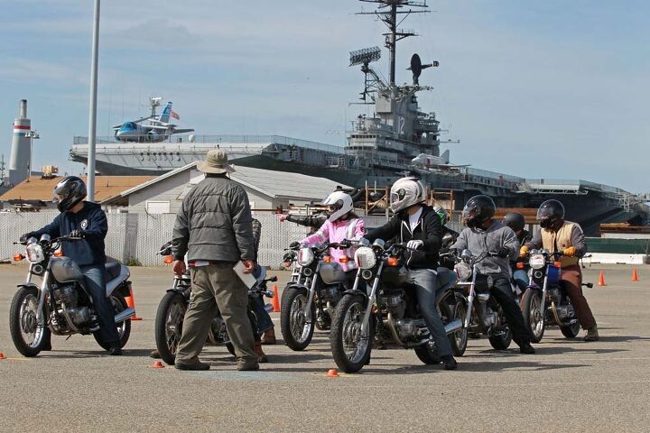 skidmarks motorcycle safety theater, MSF RiderCoach Rob Kong leads a class through a counter steering drill with the USS Hornet in the background