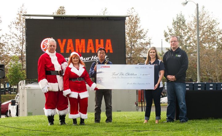 yamaha star touring and riding association and racers gather for charity and, From left to right Alan and Ginger Cease Toshi Kato President of Yamaha USA the Feed the Children representative and Dennis McNeal VP Motorcycle Operations at Yamaha USA pose with a big check for charity