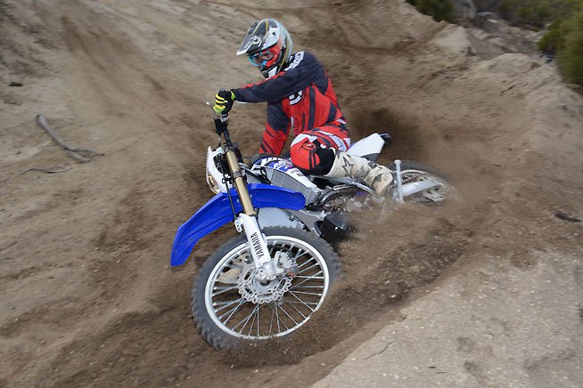 2015 yamaha wr250f first ride review, The WR handles much lighter than its 295 lb wet weight might suggest and its solid mid range thrust makes tackling sandy berms on the trail a lot of fun