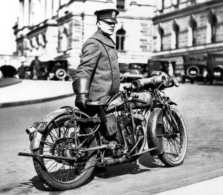 discovering dragon s teeth, What appears to be a 1918 Indian Powerplus serves as a member of the Washington D C police department and stands at the ready along with its gauntlet wearing officer The photo was snapped in 1924 With electric lighting leaf spring front suspension klaxon horn this Indian was loaded for bear The small toothed gear attached to the rear fender stay activates the siren mounted to the top of the gas tank