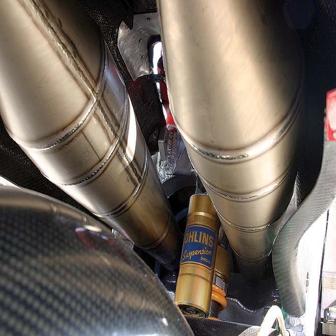 tested cagiva v593 500cc grand prix racer, The ultra expensive Ohlins remote reservoir shock sits between the titanium rear expansion chambers