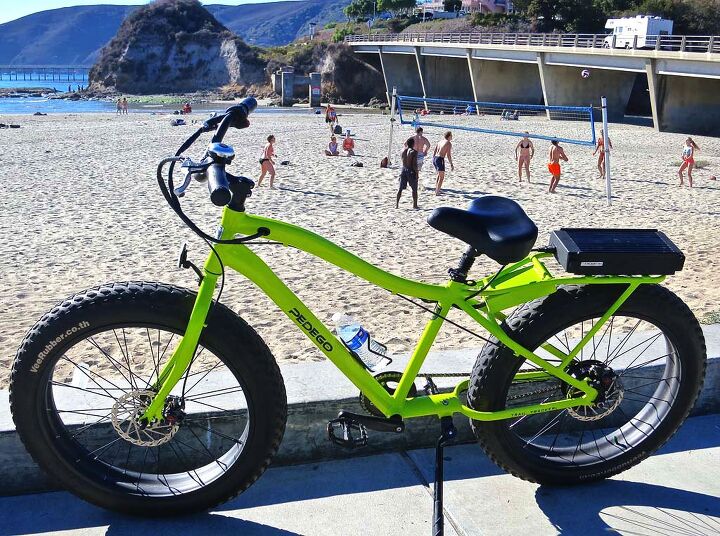 photographing motorcycles parked in front of places, Yes it is a bicycle But it has a motor An electric beach cruiser at the beach with a beach volleyball backdrop A possibility for the Avila Beach Chamber of Commerce calendar