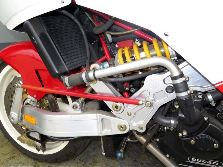 archive bimota tesi 1d sr, The Tesi theme was to separate suspension from steering That red rod allows adjusting the angle of the kingpin inside the hub what would be rake and trail on a conventional bike