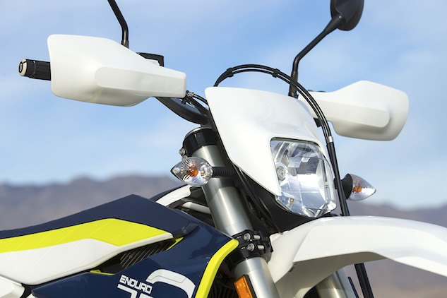 2016 husqvarna 701 enduro review, We appreciate that the Husqvarna is fitted with handguards straight from the factory but the front number plate headlight combo is shaped in such a way that if offers zero wind protection not ideal on cold or windy days