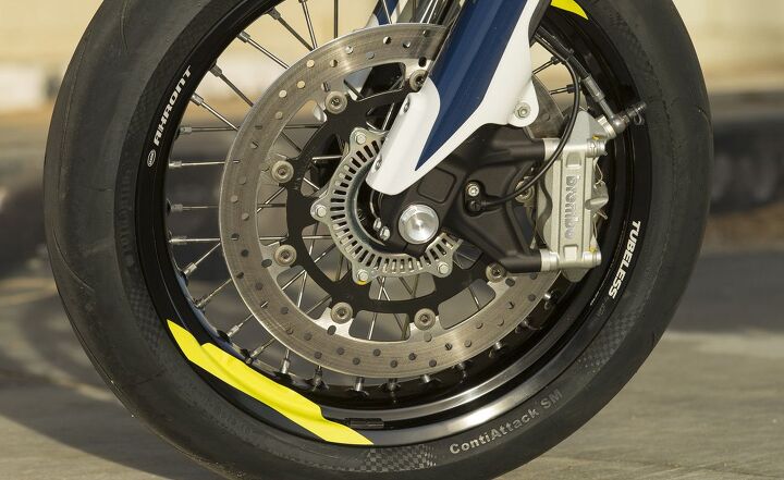 2016 husqvarna 701 supermoto review, The 701 s 320mm disc and radial mounted Brembo four piston front caliper combo deliver tremendous stopping power but is grabby Fortunately Husqvarna offers an accessory dongle that directs the Bosch two channel ABS to deactivate the rear anti lock feature