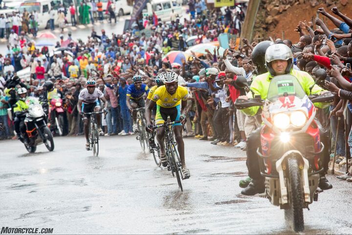 riding motorcycle support in the tour du rwanda bicycle race, In the very smallest towns life stops when the race passes through In large towns like the capital city of Kigali it is simply chaos a challenge for any motorcyclist Photo by Mjrka Boensch Bees