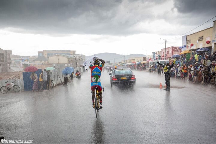 riding motorcycle support in the tour du rwanda bicycle race, During my time in Rwanda it rained every single day hard a challenge for bicycle and motorcycle riders alike Photo by Mjrka Boensch Bees