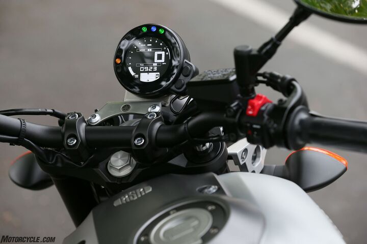 2016 yamaha xsr900 first ride review, The digital instrument cluster s blocky Atari Tetris look is actually very legible The single gauge makes good use of a small space by providing tach and speed info as well as riding mode TC setting GPI fuel gauge clock and idiot lights Toggling through odometer trip meter and other information is also available Note the right of center location of the fuel cap