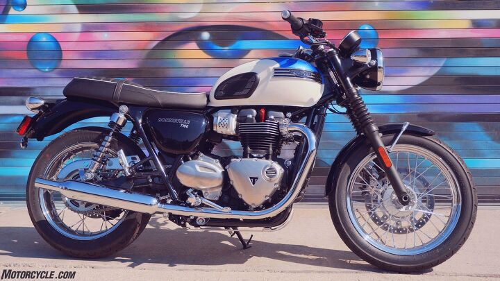 2017 triumph bonneville t100 first ride review, Keeping an eye out for the T100 Bonneville essentially a T120 Bonnie powered by the Street Twin s 900cc motor and minus a 310mm rotor and Nissin two piston caliper