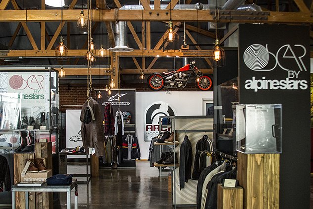 alpinestars relaunches the oscar line, Alpinestars chose the Arch Motorcycles showroom to display some pieces of its Oscar by Alpinestars line alongside some original Oscar motocross boots from the 1970s and clothing pieces from Alpinestars men s clothing line