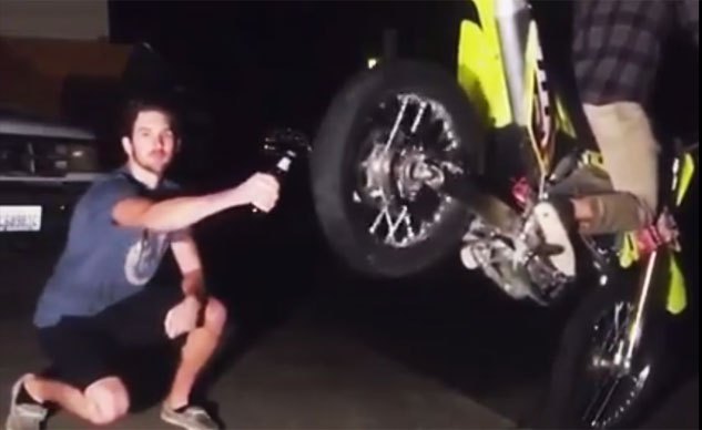 opening a beer bottle with a motorcycle