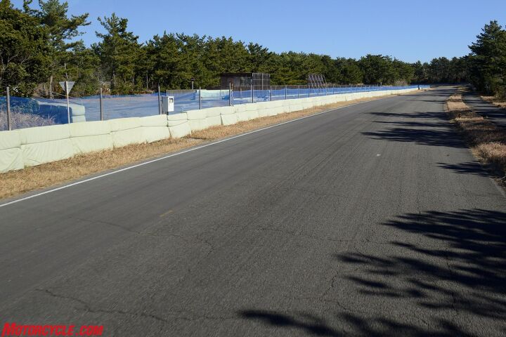 inside suzuki factory tour part 1, Unlike a proper race course the Ryuyo testing circuit has a dearth of run off room Note also the two pavement surfaces here smoother on the left side