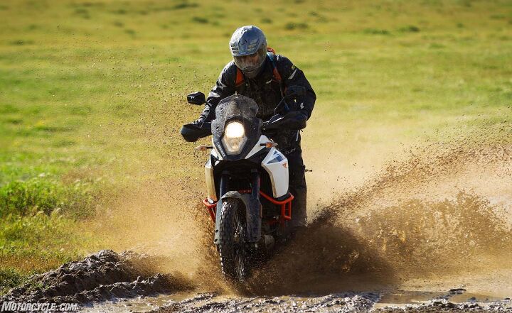 2017 ktm 1090 adventure r review first ride, It ain t an off road party until someone gets muddy Cornering ABS is gone but On and Off Road ABS MTC ride by wire throttle and the slipper clutch remain There s also a manually adjustable windscreen and brushguards that are part of the stock configuration