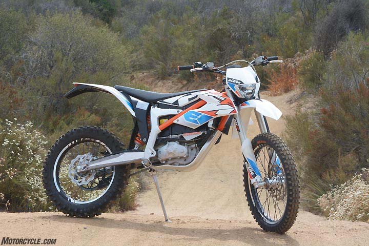 2017 ktm freeride e xc first ride review, KTM s Freeride E boasts some impressive componentry A chro moly steel section in orange mates to a cast aluminum configuration below the seat to comprise the frame while the subframe is a high tech plastic structure that helps shave weight Wheels feature aluminum rims and spoke nipples and CNC machined hubs Aluminum swingarm with a machined section shows attention to detail Without its battery the bike would weigh less than 190 pounds