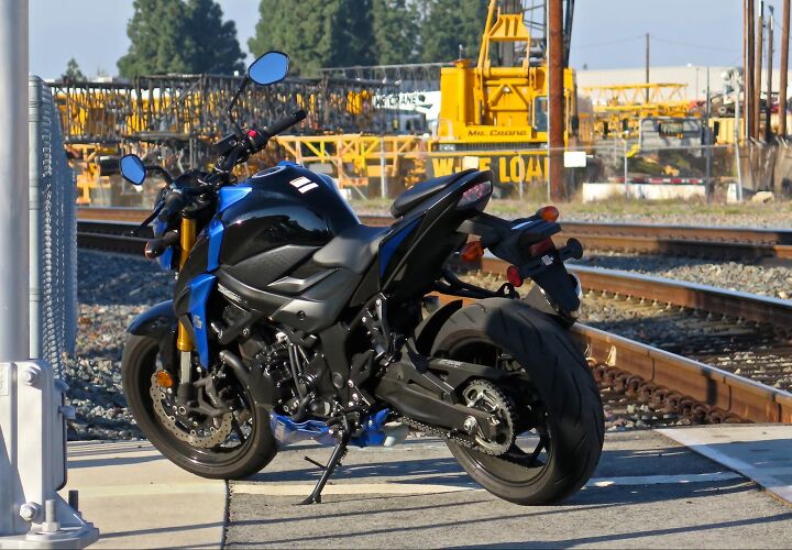 live with it suzuki gsx s750, Two helmet locks are molded into passenger seat base along with two nylon web straps to bungee things to along with the passenger peg carriers