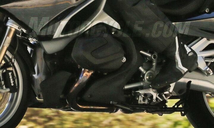 bmw r1200rt with new boxer engine spied, The cam covers aren t the only things to have changed The exhaust has a slightly different angle and doesn t jut forward as much before curving toward the rear There s now room for a bit of bodywork to protect the front of the pipe