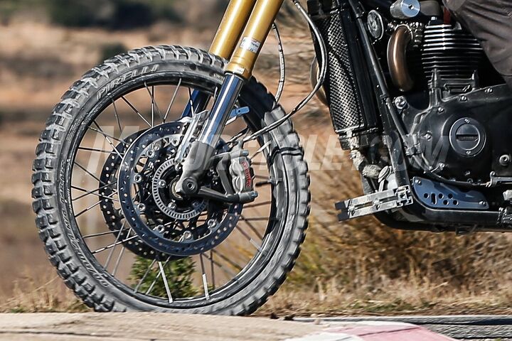 2019 triumph scrambler 1200 spied, The tire markings indicate a Pirelli 90 90 21 front tire Note how the wire spokes attach to the outside edges of the rim which means the wheels can be shod with tubeless tires
