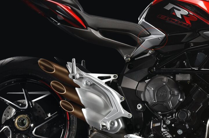 2018 mv agusta brutale 800 rr first ride review, Here you can see how the footpeg bracket is pushed outward by the exhaust and visualize how the design will also impede ankle movement Above that outlined in red is the seat tank juncture protuberance that s uncomfortable and seemingly unnecessarily MV is sometimes a victim of its form over function creations
