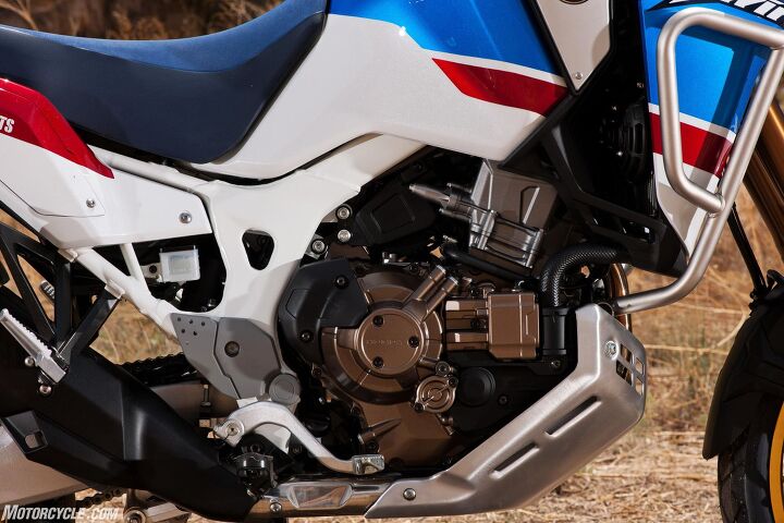 2018 honda africa twin adventure sports first ride review, Some of the extra components adding 22 pounds of weight to the DCT model can be seen on the right side of the bike Thankfully the AT AS s larger bashplate should direct flying rocks away from those extra bits and also away from the exhaust headers