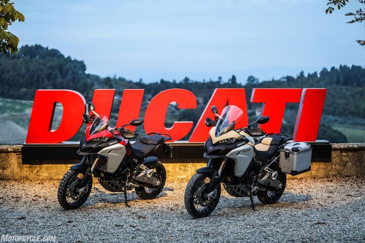 2019 ducati multistrada 1260 enduro review first ride, On the left we have the 1260 Enduro shod with Pirelli Scorpion Rally tires and a short windscreen in Ducati Red On the right is the Sand colored version with Pirelli Scorpion Trail II tires the standard windscreen which easily adjusts with a range of 60mm and Touratech accessory bags I think I prefer the red but the U S will only get the Sand color