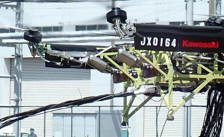 kawasaki begins testing hybrid drone powered by zx 10r engines, Two exhausts are clearly visible sticking out one side with the third partially obscured just below the JX on the banner