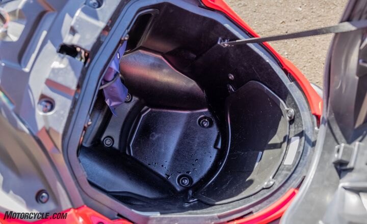 2021 honda nc750x review, Most helmets will fit in the locking bin where the gas usually goes and there s also a helmet lock loop included for ones that don t