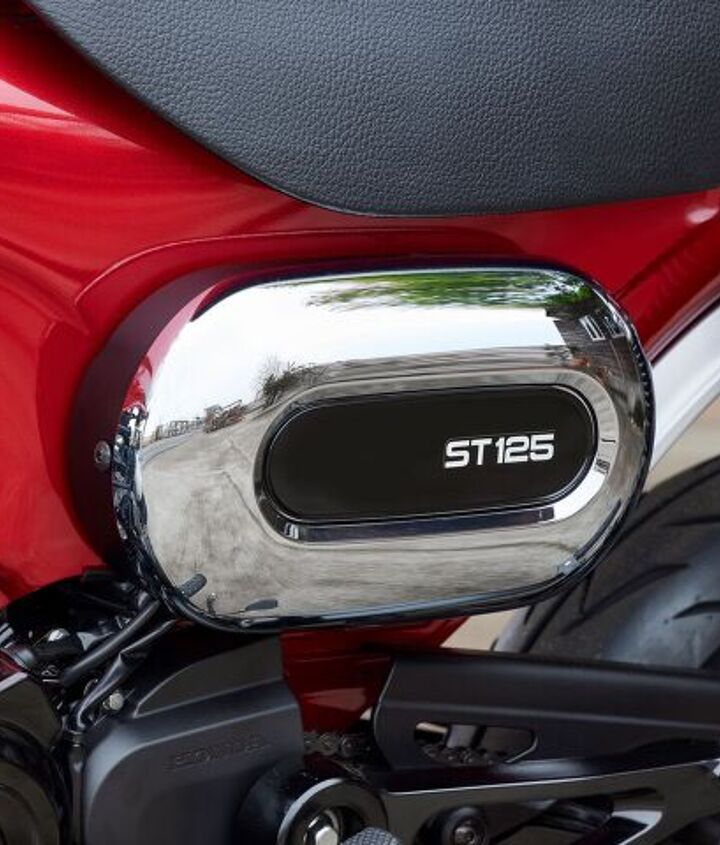 2023 honda st125 dax announced for europe, A chromed oval shaped airbox sits on the left side opposite from the exhaust