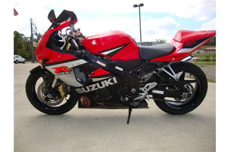 clean red black silver gixxer 600 with a scorpion exhaust and dark tinted shield