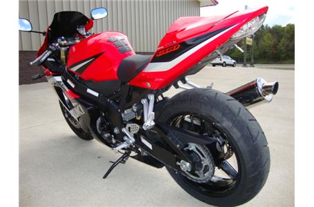 clean red black silver gixxer 600 with a scorpion exhaust and dark tinted shield