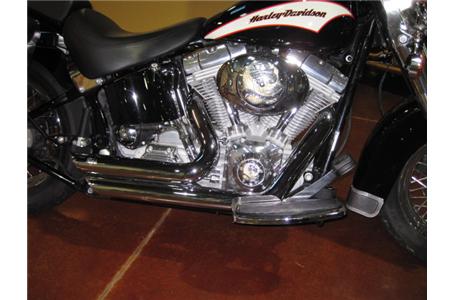 softail heritage with quick release saddlebags and vance and hines short shots