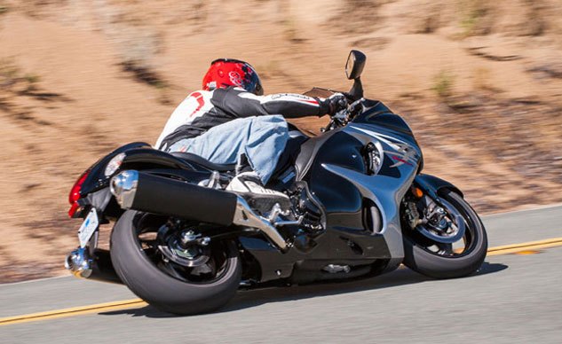 2013 suzuki hayabusa review, Weighing 586 wet pounds the Hayabusa s heft isn t trivial but its lithe handling attributes allows serious lean angles Get in a little hot however and the Busa makes its weight known