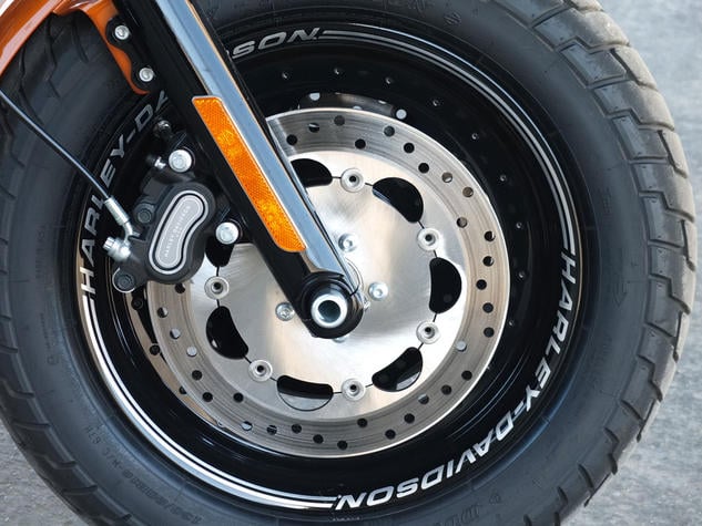 2014 harley davidson fxdf fat bob review, Also new and blacked out are the machined aluminum slotted disc wheels with Harley Davidson laser engraved around their perimeter