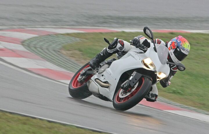 2014 ducati 899 panigale review first ride, A shorter wheelbase and more aggressive rake angle than the 1199 should make the 899 quite an agile motorcycle Unfortunately these weren t the conditions to test that theory