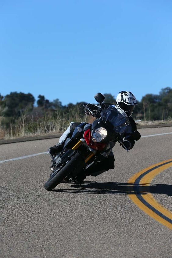 2014 suzuki v strom 1000 abs review first ride, Cornering clearance is sporty but aggressive riders will be touching down peg feelers early The next to go on the right side is the lower edge of the exhaust pipe