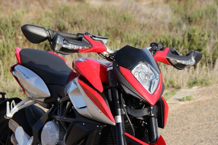 2014 mv agusta rivale review video, The Rivale s wingspan is enormous with both mirrors extended While the folding mirrors look trick the novelty fades the moment you filter through traffic On a side note the turn indicators are integrated nicely into the hand guards