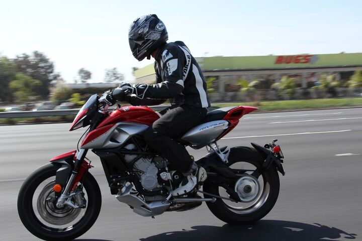 2014 mv agusta rivale review video, Long straight freeway stretches can be taxing as the upright seating position and lack of wind protection turns the rider into a sail at speed Thankfully the pegs aren t placed overtly high giving adequate legroom for average sized riders