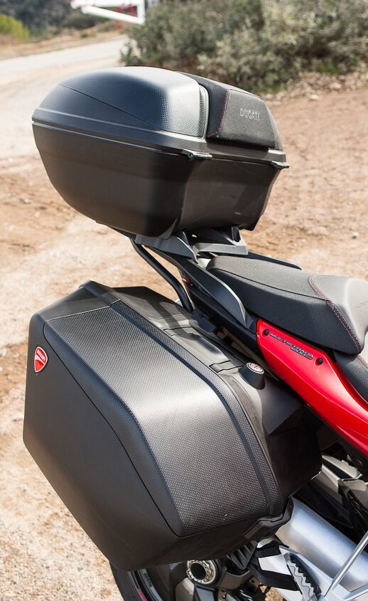 2014 ducati multistrada granturismo review, Luggage is lockable and easily detaches leaving the bike without ugly mounting bracketry The saddlebags hold 15 liters more than the S Touring model Attachment points are plastic and we re dubious of their damage resistance in even a light crash
